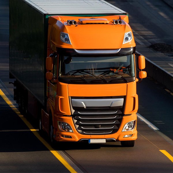 Orange moving truck on the road, representing Aus City Movers' reliable transport services for efficient
