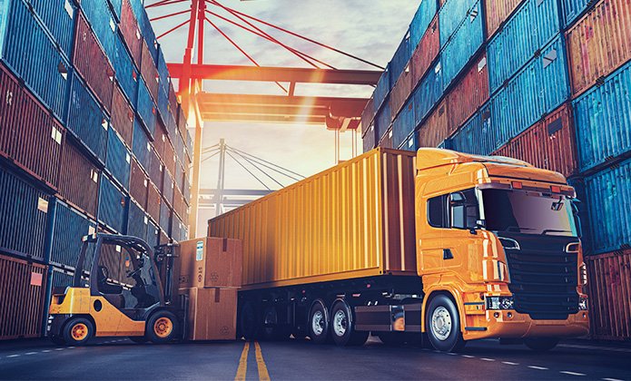 Transport truck loading containers in a shipping yard, representing Aus City Movers' transport services for